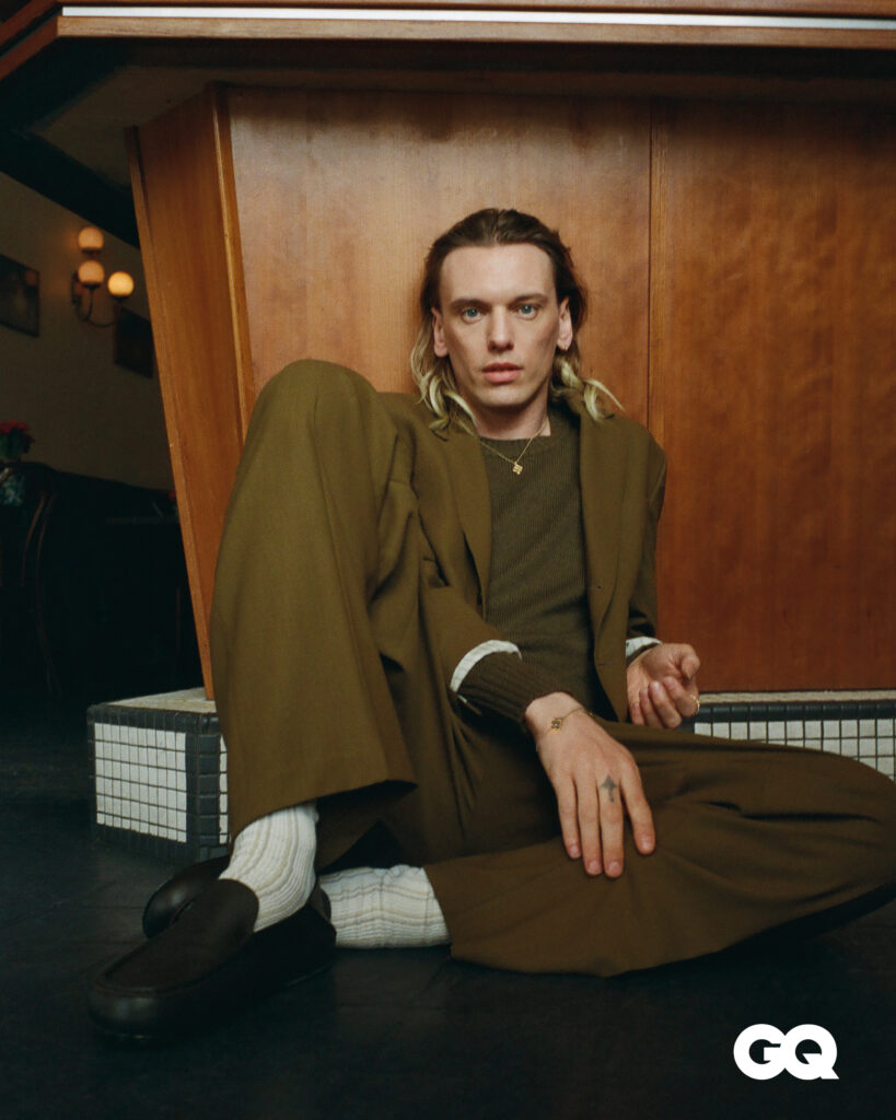 Blazer, sweater, trousers, and loafers, Tod’s. 
Socks, stylist’s own. 
Opera Tulle mini pendant in yellow gold with mother-of-pearl and bracelet in white and yellow gold, Buccellati. 
